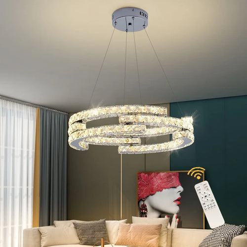 Three-light unique LED chandelier with modern statement design by TheChandelierCo hanging with sleek metallic finishes.