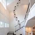 Eight-light cluster chandelier by TheChandelierCo featuring modern design with multiple hanging light bulbs and sleek metal finish.