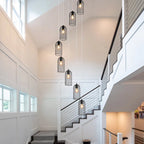 Eight-light cluster chandelier by TheChandelierCo featuring modern design with multiple hanging light bulbs and sleek metal finish.
