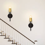 Pair of Ambellina iron armed sconces by TheChandelierCo with vintage-inspired metal arms and candle-style light holders.