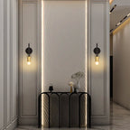 Set of two Ambellina iron armed sconces with vintage-style metal arms and candle-like light holders for wall lighting.