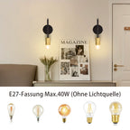 Pair of Ambellina iron armed sconce wall lights with curved arms and candle-style bulbs for classic interior decor.