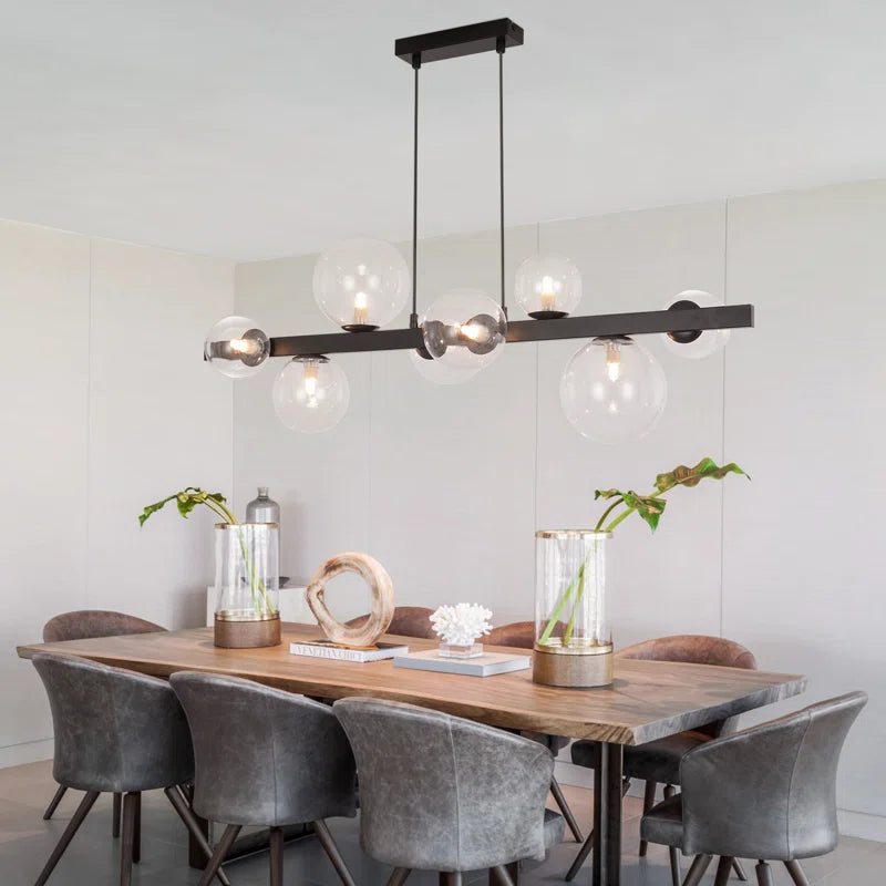 Light matte black sphere pendant light from the Ammanda 8 series by TheChandelierCo hanging from a ceiling fixture.