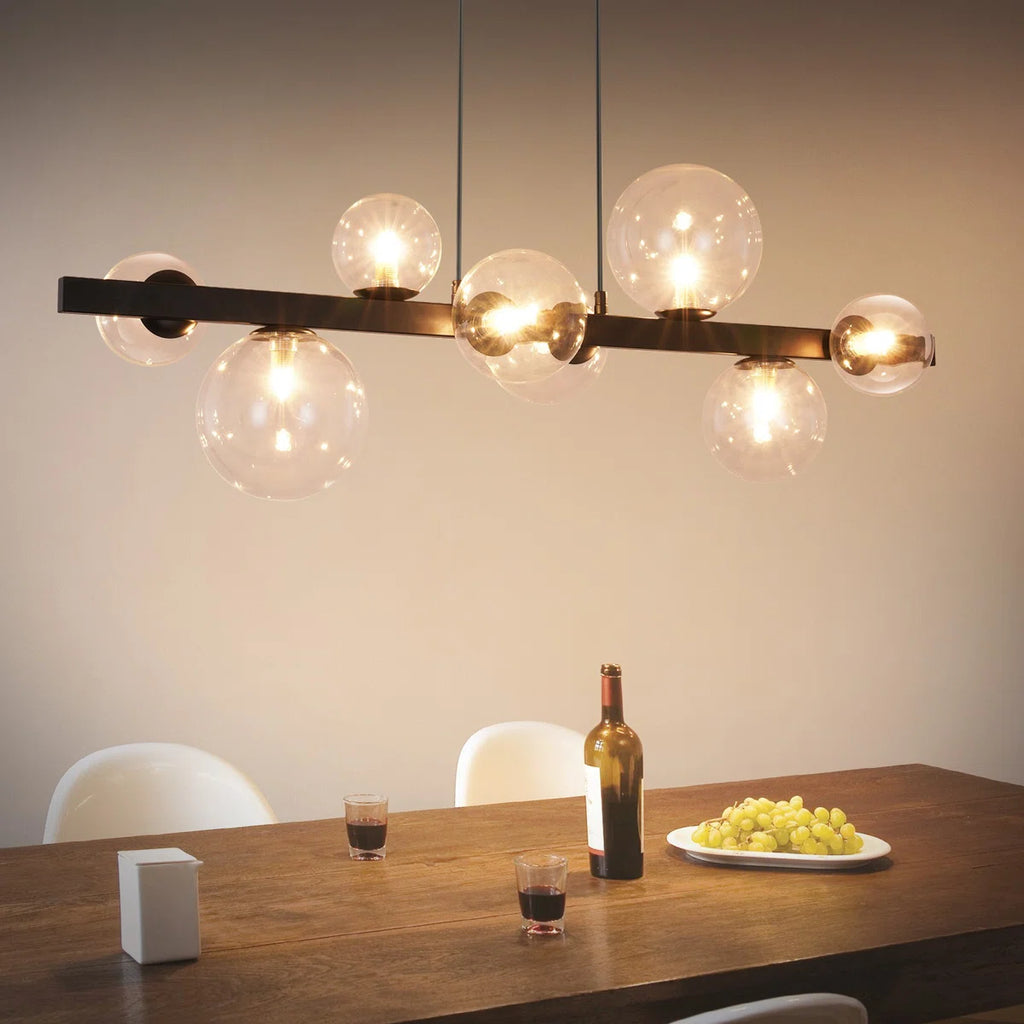 Light matte black sphere pendant light from the Ammanda 8 collection by TheChandelierCo, hanging with a sleek, modern design.