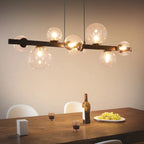 Light matte black sphere pendant light from the Ammanda 8 collection by TheChandelierCo, hanging with a sleek, modern design.