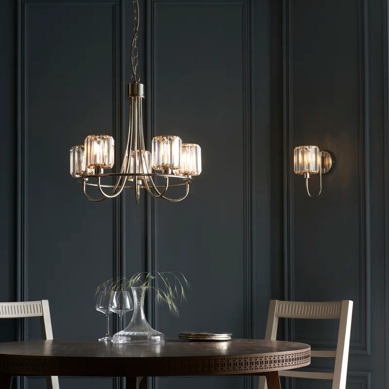 Steel and glass armed sconce by TheChandelierCo featuring a modern design with a sleek metal arm and clear glass shade.