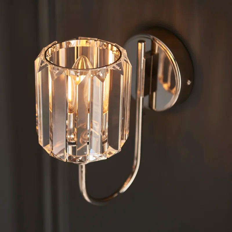 Steel and glass armed sconce by TheChandelierCo featuring a modern design with a sleek metal arm and clear glass shade.