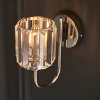 Steel and glass armed sconce by TheChandelierCo featuring a modern design with a sleek metal arm and clear glass shade.