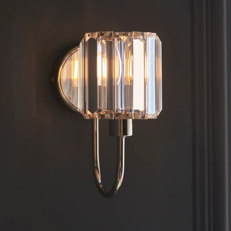 Steel and glass armed sconce by TheChandelierCo featuring a modern design with a sleek steel frame and glass shade.