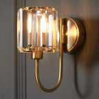 Steel and glass armed sconce by TheChandelierCo featuring a modern design with a sleek metal arm and clear glass shade.