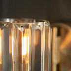 Steel and glass armed sconce from Ampelius by TheChandelierCo, featuring a sleek modern design with a metal arm and glass shade.
