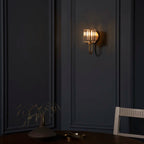 Steel and glass armed sconce by TheChandelierCo featuring a modern design with a sleek metal arm and glass shade.
