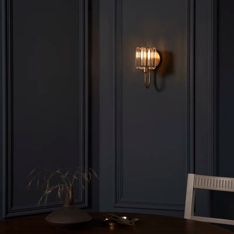 Steel and glass armed sconce by TheChandelierCo featuring a modern design with a sleek metal arm and glass shade.
