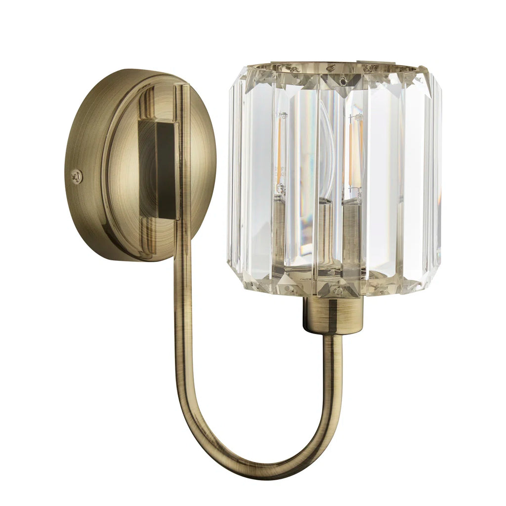 Steel and glass armed sconce by TheChandelierCo featuring modern design with a sleek metal arm and clear glass shade.