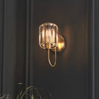 Steel and glass armed sconce by TheChandelierCo featuring a modern design with a sleek metal arm and clear glass shade.
