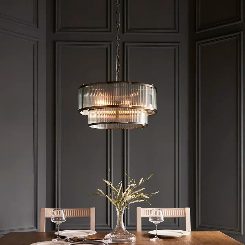 Anesty 5-light pendant chandelier in antique brass finish with elegant metal shades, designed for modern or vintage interior lighting.