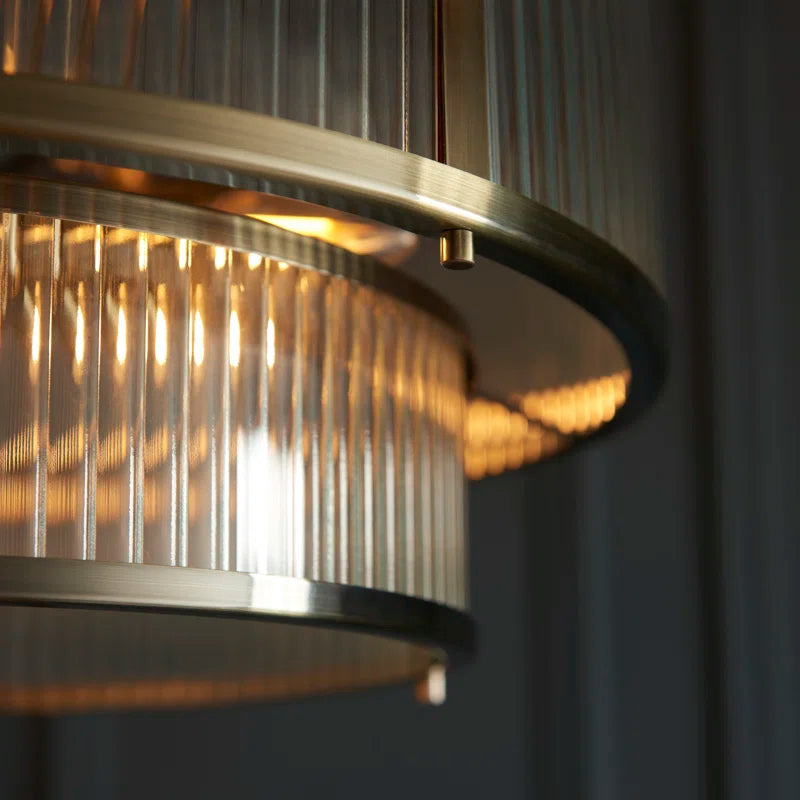 Anesty 5-liter pendant light by TheChandelierCo in antique brass finish hanging with visible metal details and warm lighting.