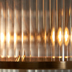 Anesty 5-liter pendant light by TheChandelierCo with antique brass finish, featuring a sleek modern design and multiple hanging lights.