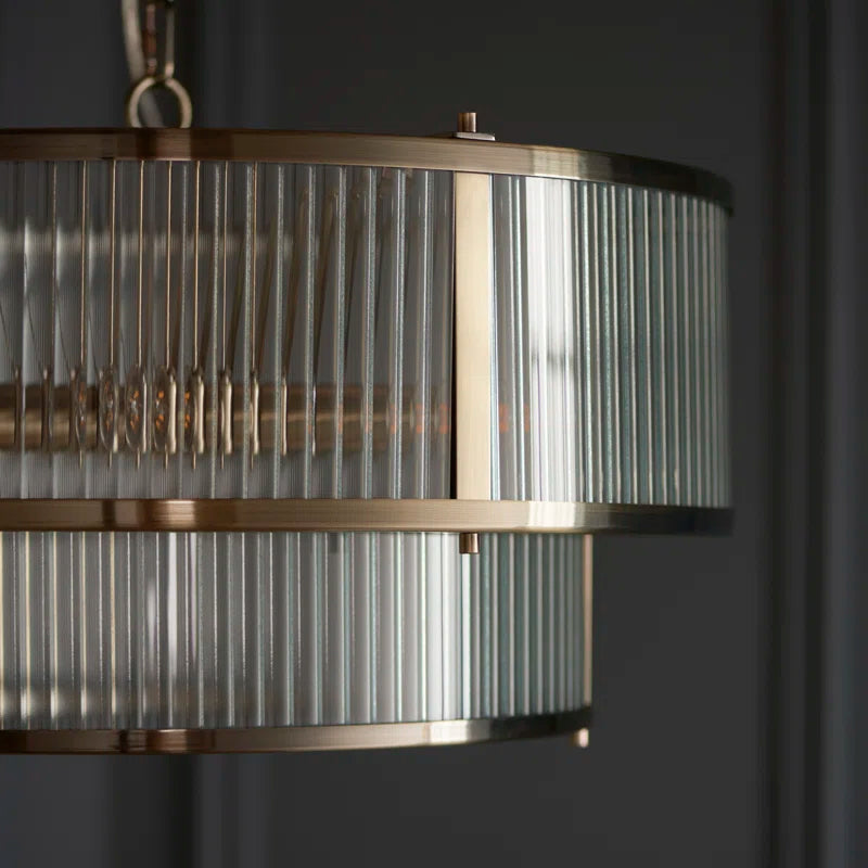 Anesty 5-light pendant chandelier by TheChandelierCo with antique brass finish and classic design, hanging with visible light fixtures.