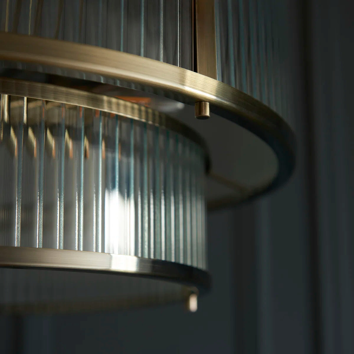 Anesty 5-liter pendant light by TheChandelierCo with antique brass finish, featuring a sleek modern design and multiple hanging lights.