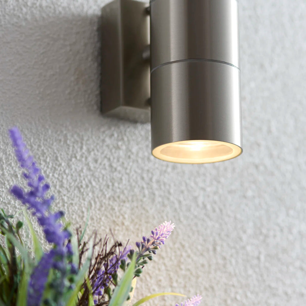 Silver outdoor armed sconce by TheChandelierCo with a 16.5cm bulb, wall-mounted lighting fixture for exterior spaces.