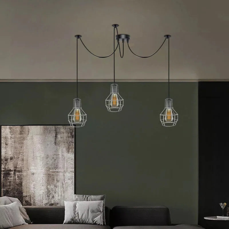Barner 3 light chandelier by TheChandelierCo featuring a modern design with multiple hanging light bulbs and sleek metal finish.