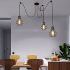 Elegant Barner 3 light chandelier by TheChandelierCo with multiple hanging lights and a sleek modern design.