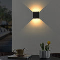 Black Betheny outdoor LED sconce by TheChandelierCo, 10cm high, with integrated lighting and sleek modern design.
