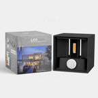 Black Betheny outdoor LED sconce by TheChandelierCo, 10cm high, with integrated lighting, mounted on exterior wall.