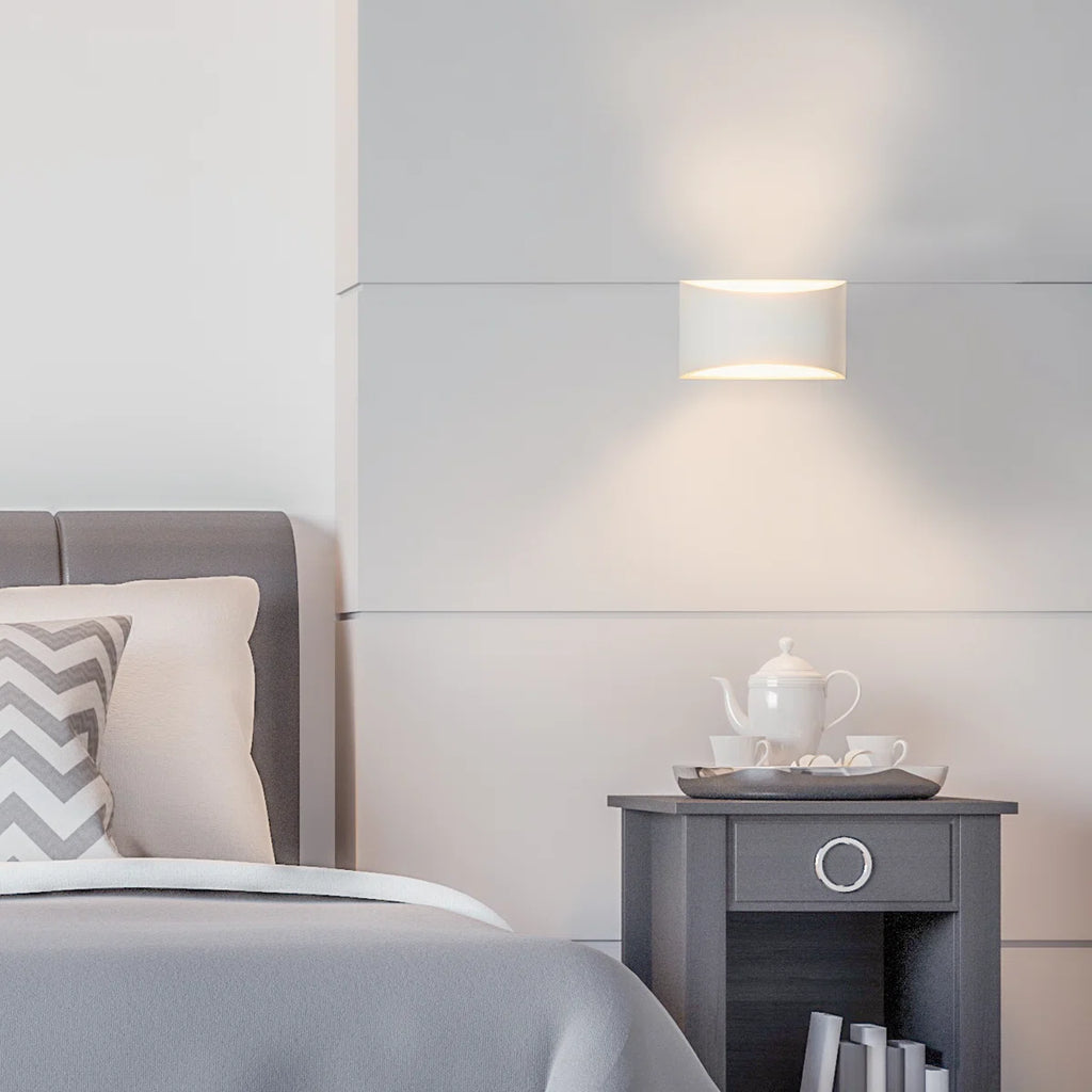 Blandford flush mounted sconce by TheChandelierCo featuring a sleek metal fixture with a frosted glass shade for ambient lighting.