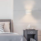 Blandford flush mounted sconce by TheChandelierCo featuring a sleek metal fixture with a frosted glass shade for ambient lighting.