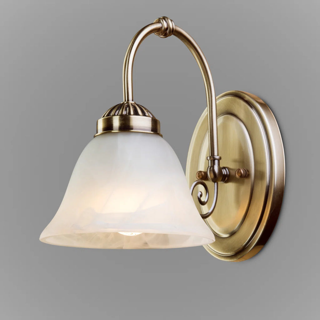 Brazell 1-light dimmable brass armed sconce with alabaster-style glass shade, mounted on a wall for vintage-inspired lighting.
