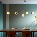 Cadel Impressive 5-light antique brass linear chandelier with sleek modern design and elegant candle-style bulbs.