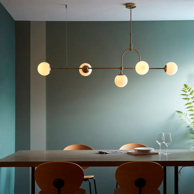Cadel Impressive 5-light antique brass linear chandelier with sleek modern design and elegant candle-style bulbs.