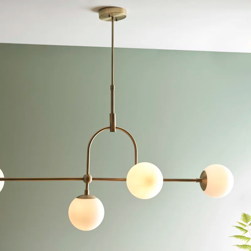 Five-light antique brass linear chandelier with modern design, featuring sleek metal arms and elegant light fixtures for stylish illumination.