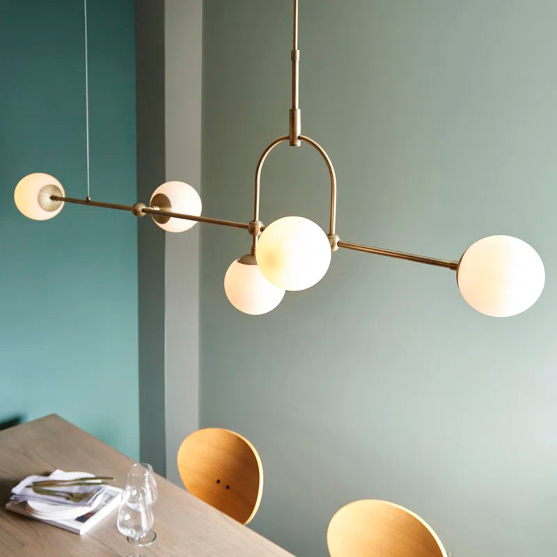 Cadel Impressive 5-light antique brass linear chandelier with sleek modern design and five candle-style light fixtures.