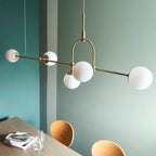 Cadel Impressive 5-light antique brass linear chandelier with modern design and elegant metal frame, hanging from ceiling.