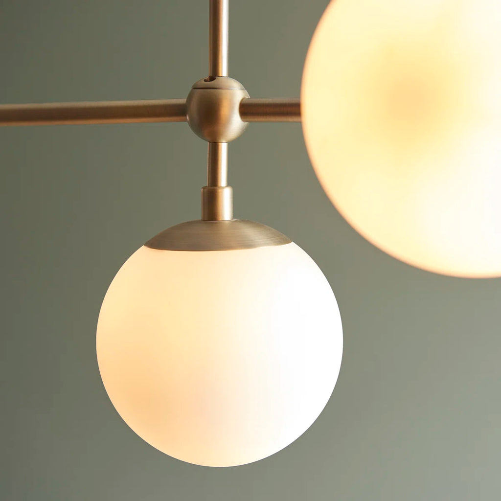 Five-light antique brass linear chandelier by TheChandelierCo featuring modern design and elegant metal finish.