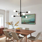 Modern Cobina 6 light Sputnik chandelier by TheChandelierCo featuring a metallic finish and six spherical glass bulbs.