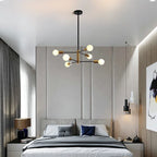 Modern Cobina 6 Light Sputnik Chandelier by TheChandelierCo featuring a brushed metal finish and six exposed bulbs against a neutral background.