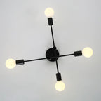Coblitz 4 light Sputnik chandelier by TheChandelierCo with a modern brass finish and four spherical glass bulbs.