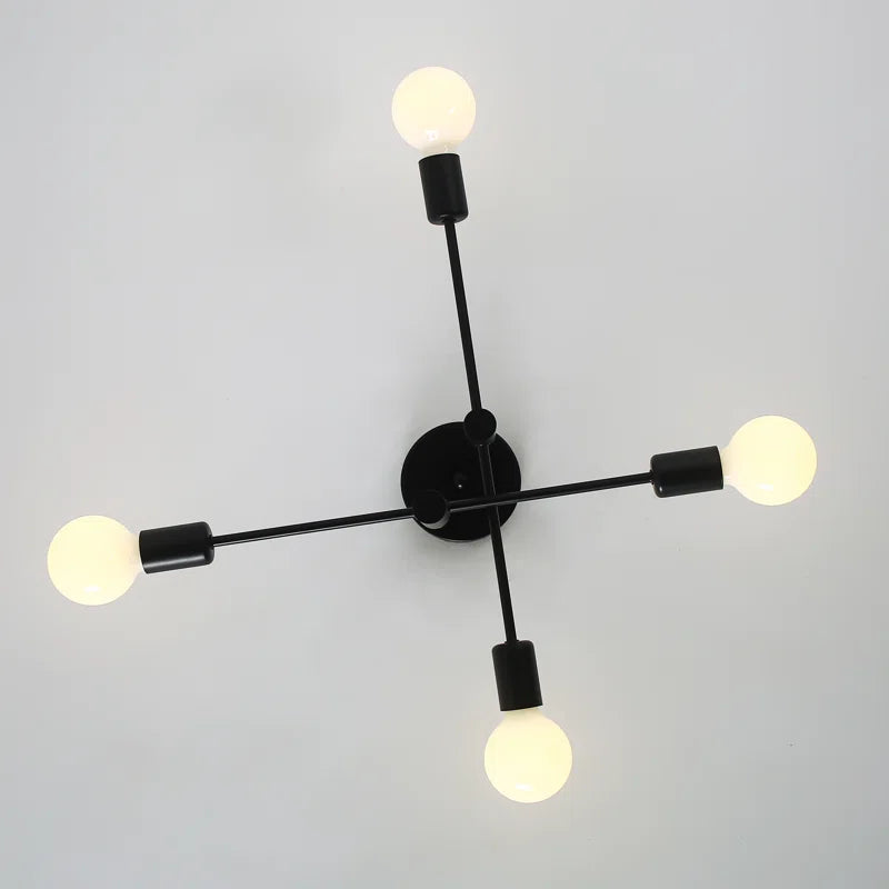Coblitz 4 light Sputnik chandelier by TheChandelierCo with a modern brass finish and four spherical glass bulbs.