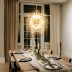 Dandelion 12-light Sputnik crystal chandelier with starburst design, hangs from ceiling, featuring multiple crystal arms and modern style.
