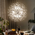 Dandelion 9-light Sputnik crystal chandelier with starburst design, hanging from ceiling with crystal accents and metal frame.