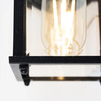 Black outdoor wall lantern by TheChandelierCo featuring a classic design and clear glass panels for outdoor illumination.