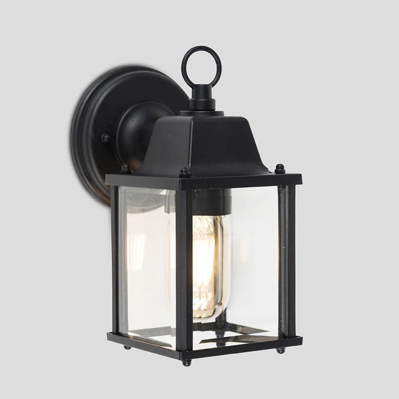 Black outdoor wall lantern by TheChandelierCo with classic design, mounted on a wall for exterior lighting and decoration.