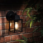 Black outdoor wall lantern by TheChandelierCo with a classic design, suitable for exterior lighting and decorative outdoor spaces.