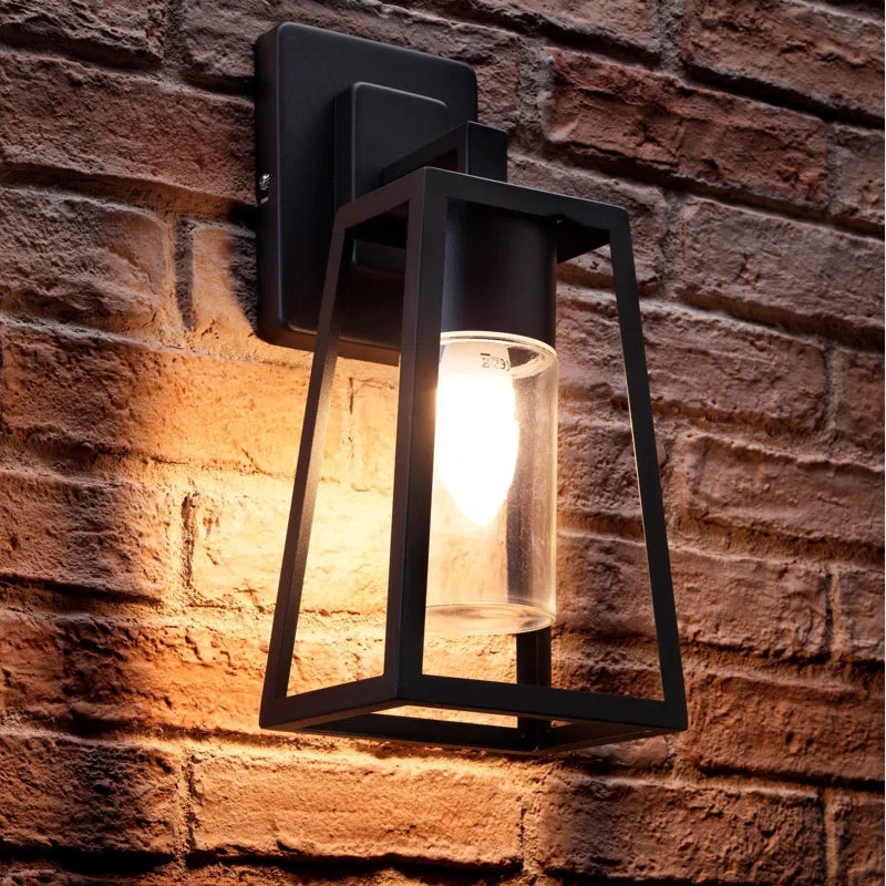 Black outdoor wall lantern by TheChandelierCo, 37.5cm tall with warm white lighting for exterior illumination.