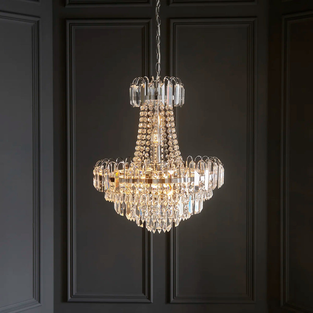 Jayla 6 light chandelier by TheChandelierCo featuring a modern design with six elegant light fixtures and a sleek metal frame.