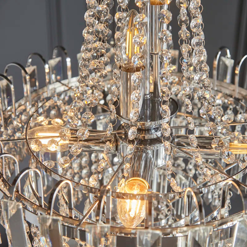 Elegant Jayla 6 light chandelier by TheChandelierCo featuring a modern design with six illuminated light fixtures and a sleek finish.